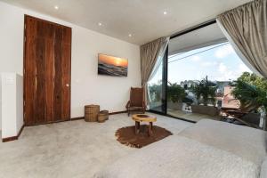a bedroom with a bed and a large window at Samsara Tulum Boutique in Tulum