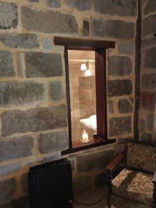a room with a stone wall with a window at The Stone House Stay Connect Explore in Pokolbin