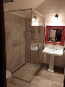 a bathroom with a glass shower and a sink at The Stone House Stay Connect Explore in Pokolbin