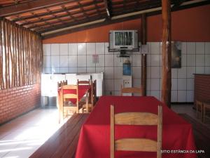 a dining room with a red table and chairs at SITIO ESTANCIA DA LAPA in Sao Jose da Lapa