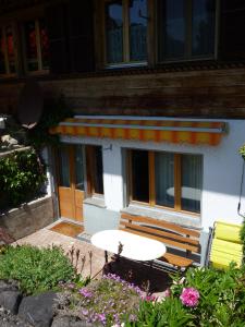 a table and chairs in front of a building at Chalet Aebnetbode in Gstaad