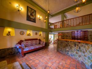 a living room with a couch and a staircase at Sol Ollantay Exclusive Hotel in Ollantaytambo