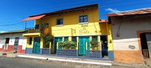 a brightly colored building on the side of a street at Hotel Al Sole in León +56 photos