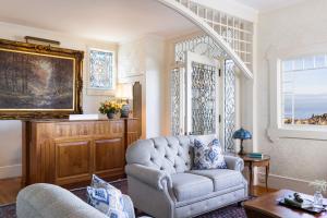 a living room with a couch and a chair at Seven Gables Inn on Monterey Bay, A Kirkwood Collection Hotel in Pacific Grove