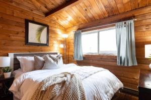 a bedroom with a bed in a wooden wall at Muskoka Ski Chalet in Huntsville