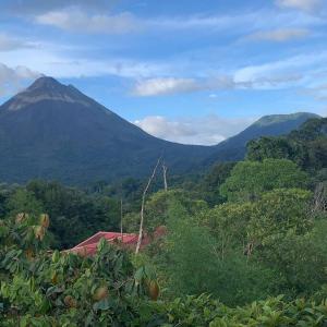 a view of a mountain with a house and trees at Retana Apartment in Quesada