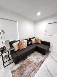 a black couch sitting in a living room at NEW Comfy and Modern House near Miami Airport in Miami