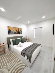 a bedroom with a large white bed and a rug at NEW Comfy and Modern House near Miami Airport in Miami