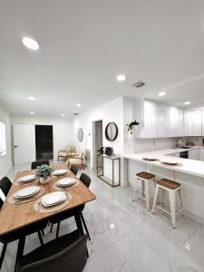 a dining room and kitchen with a table and chairs at NEW Comfy and Modern House near Miami Airport in Miami
