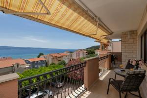 a balcony with a view of the ocean at Room 79-2 in Duće