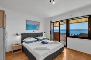 a bedroom with a bed with a view of the ocean at Room 79-2 in Duće