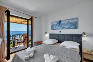 a bedroom with a bed and a view of the ocean at Room 79-3 in Duće