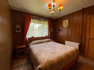 Postel nebo postele na pokoji v ubytování Hostal el Nogal Pucón