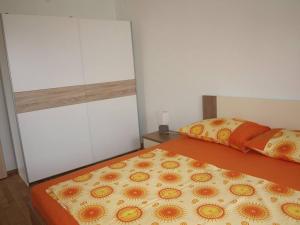 a bedroom with a bed with two pillows on it at Apartment in Slatine with sea view, balcony, air conditioning, Wi-Fi (4784-2) in Slatine