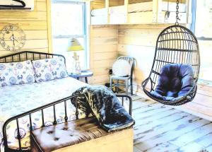 a bedroom with a bed and a swing at The Offbeat Oasis by the Marsh with Hunting Island Beach Pass in St. Helena Island