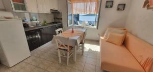 a small kitchen with a table and a couch at Apartment in Sevid with Seaview, Terrace, WIFI (4746-2) in Sevid
