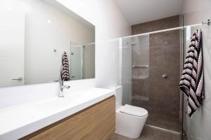 a bathroom with a toilet and a sink and a shower at Luxury private ensuite room close to Airport,City, Genelg Beach in Plympton