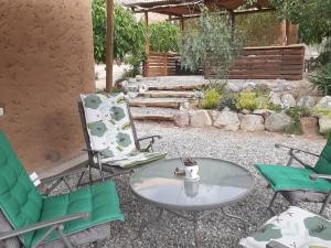 patio z krzesłami, stołem i krzesłami w obiekcie Cabaña entre Nogales w mieście Horcon