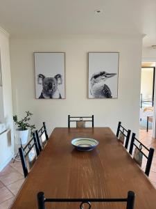 a dining room table with a dog on the wall at Vista Di Mare in Lorne +4 photos