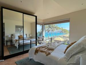 a bedroom with a bed and a view of the ocean at Vista Di Mare in Lorne
