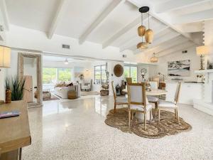 a large living room with a table and chairs at The Pink Flamingo Mid Century Heated Pool Paradise in Sarasota