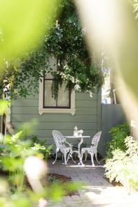 a patio with a table and chairs in front of a house at Centrella Hotel, a Kirkwood Collection Hotel in Pacific Grove