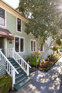 a green house with stairs in front of it at Centrella Hotel, a Kirkwood Collection Hotel in Pacific Grove