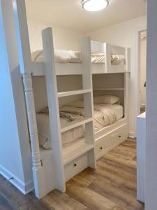 a room with white bunk beds in a room at Shores of Panama Unit 1209 in Panama City Beach