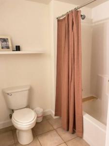 a bathroom with a toilet and a shower curtain at Shores of Panama Unit 1209 in Panama City Beach