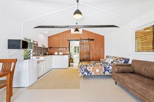 a kitchen and a living room with a couch at The Beach Shack at Dalmeny in Dalmeny