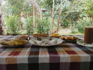 a table with a platter of food on it at Sigiri Green Shadow Homestay in Sigiriya