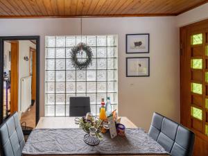 a dining room with a table and a large window at Home with Sauna & Terrace in Suhl