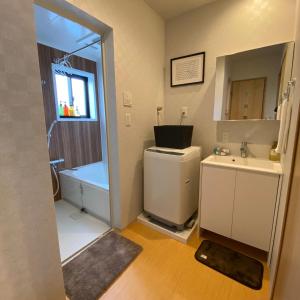 a bathroom with a sink and a toilet and a shower at Guest House One More Heart at Kyoto Station South 6 in Nishi-kujō-Toriiguchichō