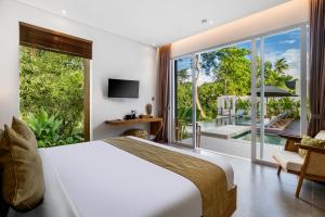 a bedroom with a bed and a view of a patio at Villa Markandeya by BaliSuperHost in Ubud