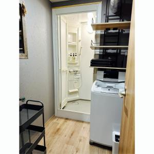 a kitchen with a refrigerator and a washer and dryer at CABIN Nozawaonsen in Nozawa Onsen +14 photos