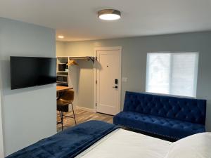 a bedroom with a blue bed and a blue couch at The Homestead in Palisade