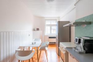 eine Küche mit einem Tisch und Stühlen sowie einem Kühlschrank in der Unterkunft Lena Apartment Děčín in Děčín