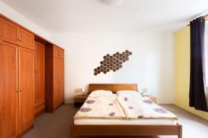 a bedroom with a bed with a wooden head board at Lena Apartment Děčín in Děčín