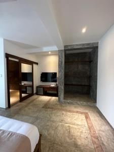a bedroom with a bed and a tv in a room at Ami Mirissa in Mirissa