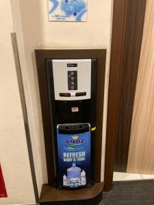a drink machine in the corner of a room at Desatu Hotel in Medan