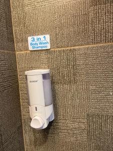 a small white appliance on the side of a wall at Desatu Hotel in Medan