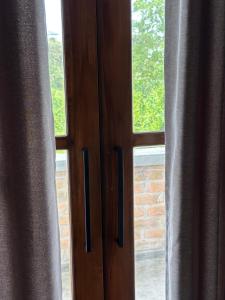 a close up of a pair of windows with curtains at Ami Mirissa in Mirissa