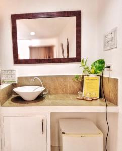 a bathroom with a sink and a mirror at Bulskamp Inn in El Nido
