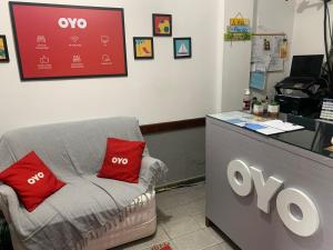 ein Zimmer mit einer Couch mit roten Kissen darauf in der Unterkunft Pousada Solari s in Rio das Ostras