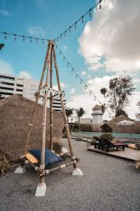 a wooden swing with a blue pillow on it at The Pattaya Glamper in Pattaya North