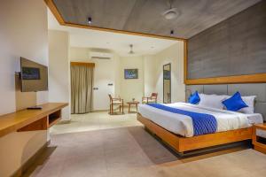 een slaapkamer met een groot bed en een bureau bij HOTEL CASON INTERNATIONAL in Kondotti
