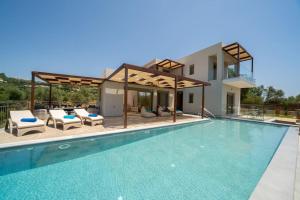 a villa with a swimming pool and a house at Luxury Villa Majore in Svoronata