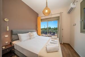 a bedroom with a large bed and a large window at Luxury Villa Majore in Svoronata +44 photos