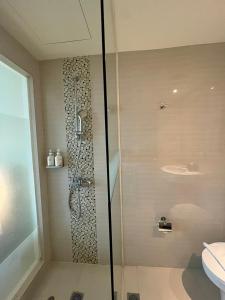 a glass shower in a bathroom with a toilet at Holiday Inn Express Jakarta International Expo, an IHG Hotel in Jakarta