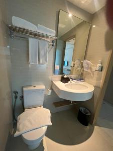 La salle de bains est pourvue de toilettes blanches et d'un lavabo. dans l'établissement Holiday Inn Express Jakarta International Expo, an IHG Hotel, à Jakarta